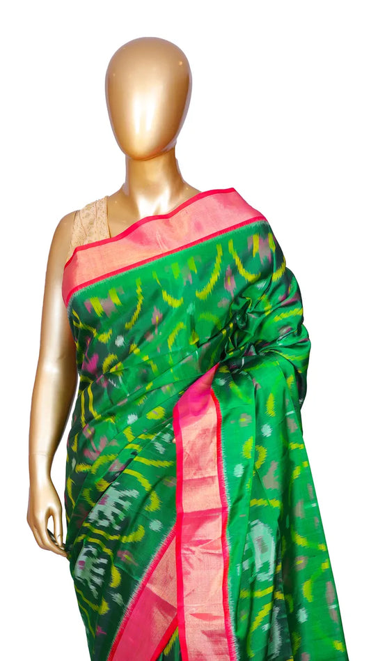 Bottle green pure silk Ikkat Patola saree with contrast pink border, pallu, and blouse