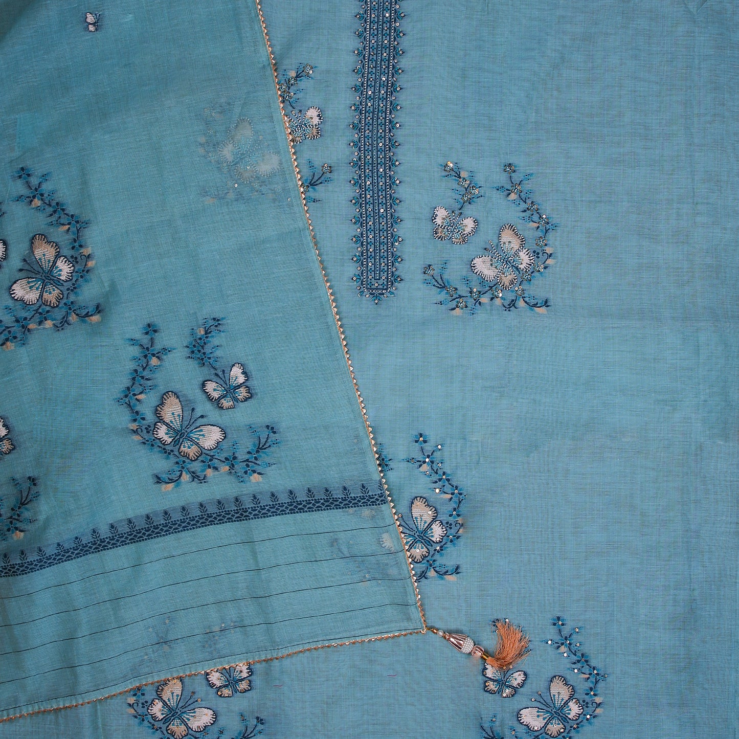 Firozi blue Chanderi silk unstitched suit with resham weaving butterfly motifs and light pearl and bead work on neckline