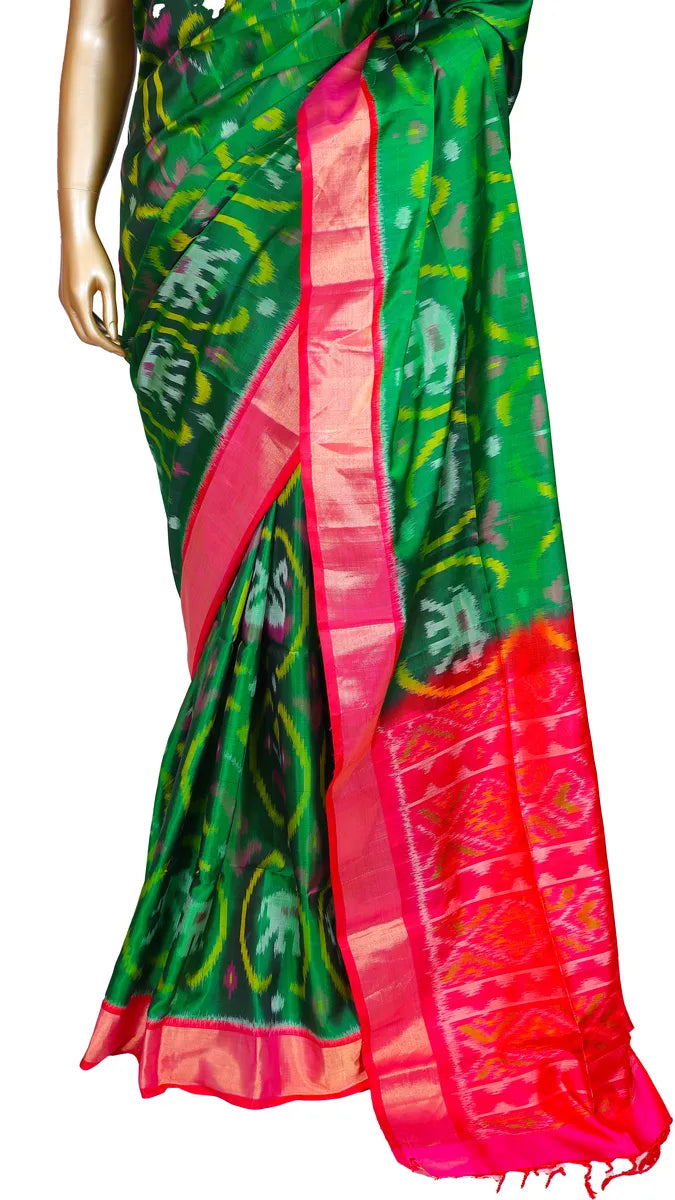 Bottle green pure silk Ikkat Patola saree with contrast pink border, pallu, and blouse