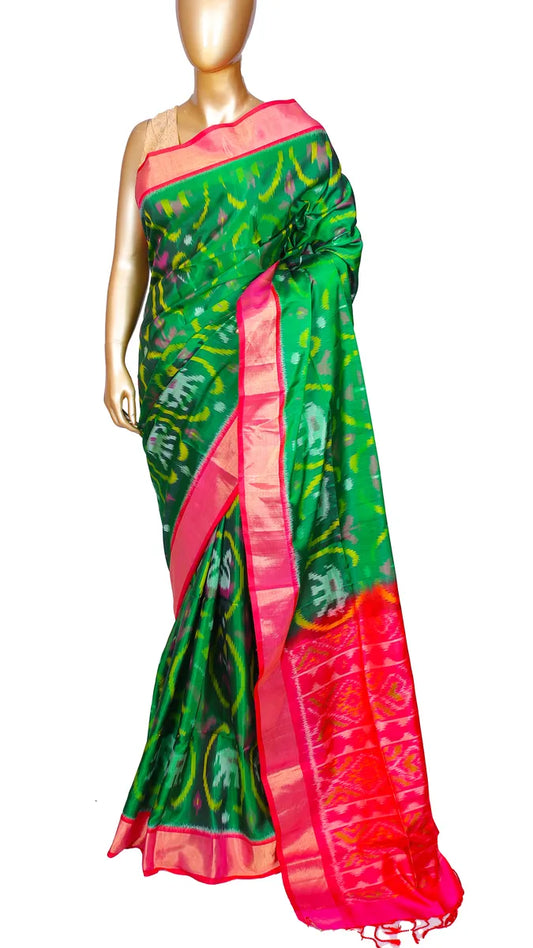 Bottle green pure silk Ikkat Patola saree with contrast pink border, pallu, and blouse